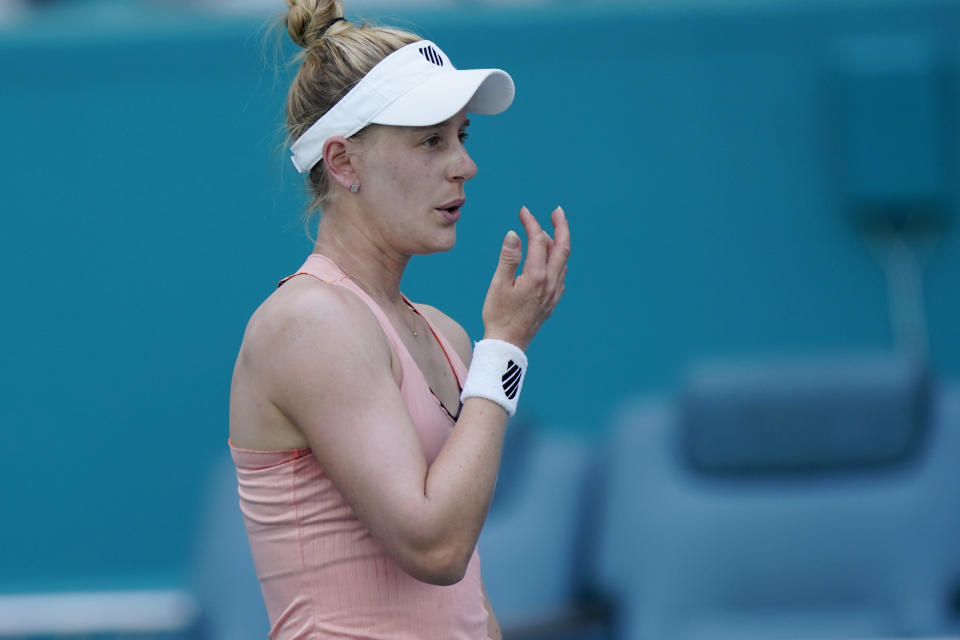 Alison Riske blows on her fingers as she waits for a serve from Naomi Osaka of Japan, during the Miami Open tennis tournament, Monday, March 28, 2022, in Miami Gardens, Fla. (AP Photo/Wilfredo Lee)