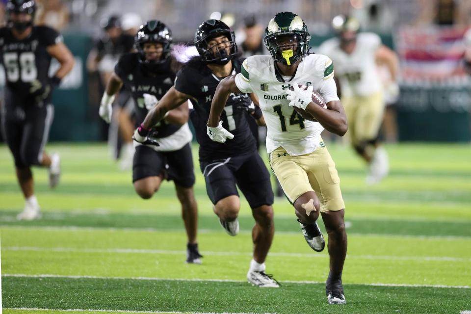 Colorado State wide receiver Tory Horton (14) runs in a touchdown against Hawaii during the second half of an NCAA college football game, Saturday, Nov. 25, 2023, in Honolulu. (AP Photo/Marco Garcia)
