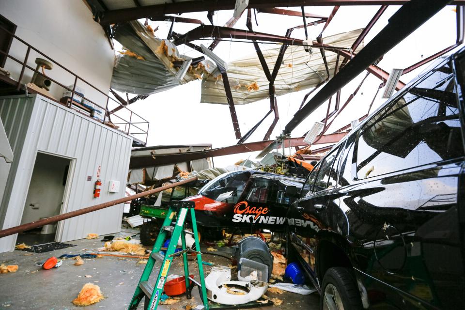A helicopter is damaged in a hangar at Air Flite Inc. near the Oklahoma Baptist University campus on Thursday after a Wednesday night storm in Shawnee.