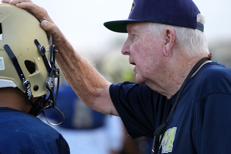 Defensive Coordinator Bob Burt works with his players on the La Joya Community High School Lobos football team as they practice on their field in Avondale Thursday, Aug. 18, 2022.