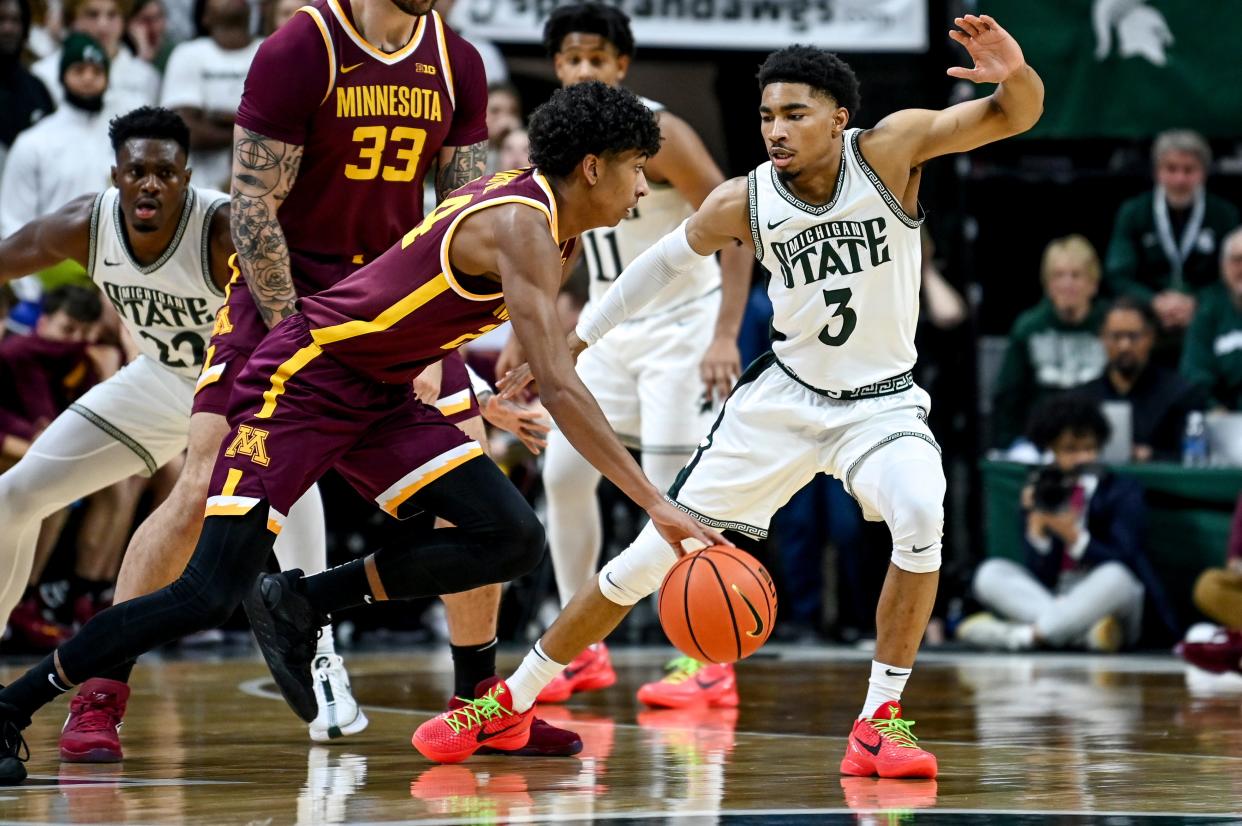 Michigan State's Jaden Akins, right, guards Minnesota's Cam Christie, the brother of Max Christie, during the second half their game on Jan. 18 at the Breslin Center in East Lansing.
