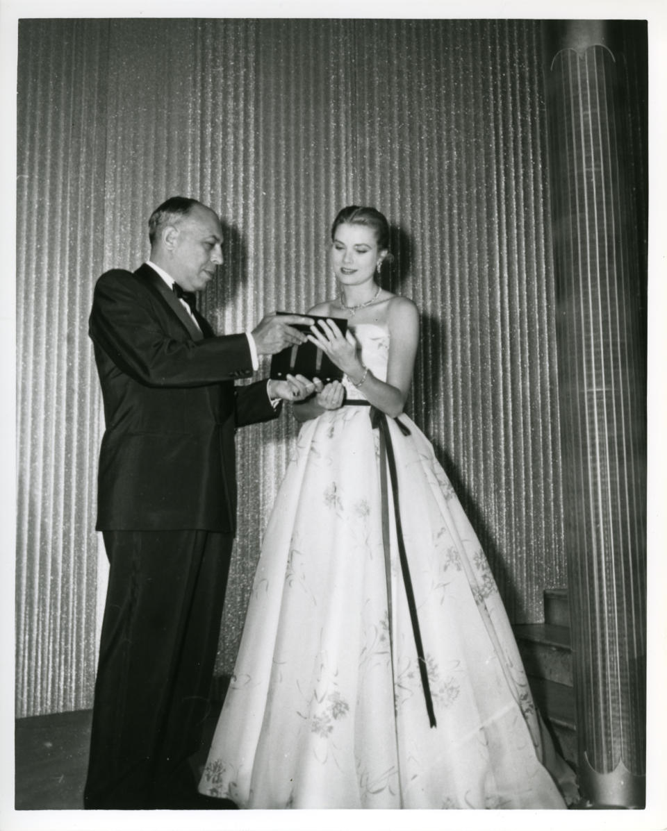 Grace Kelly receiving the Neiman Marcus Fashion Award from Stanley Marcus, 1955
