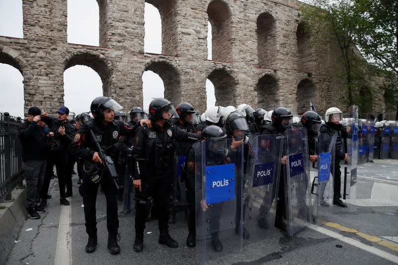 Turkish riot police block a main road to prevent May Day demonstrators from marching through Taksim Square in Istanbul