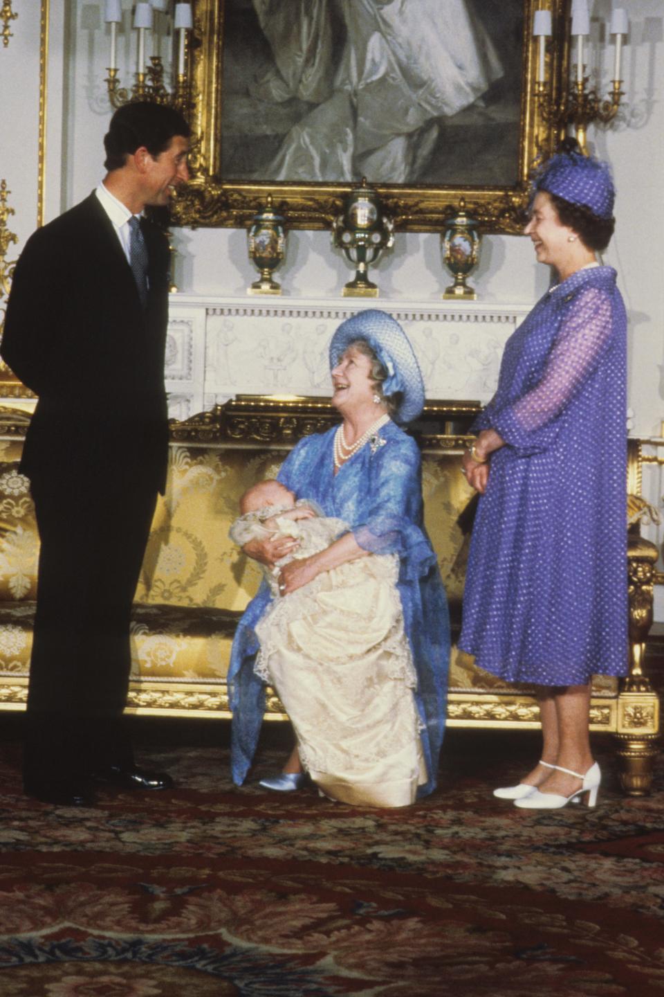 The Queen Mother holds Prince William at his christening as Prince Charles and Queen Elizabeth look on.