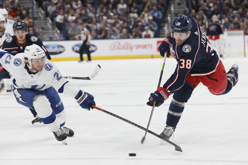 Tampa Bay Lightning's Brayden Point, left, tries to block a shot by Columbus Blue Jackets' Boone Jenner during the second period of an NHL hockey game Friday, Oct. 14, 2022, in Columbus, Ohio. (AP Photo/Jay LaPrete)