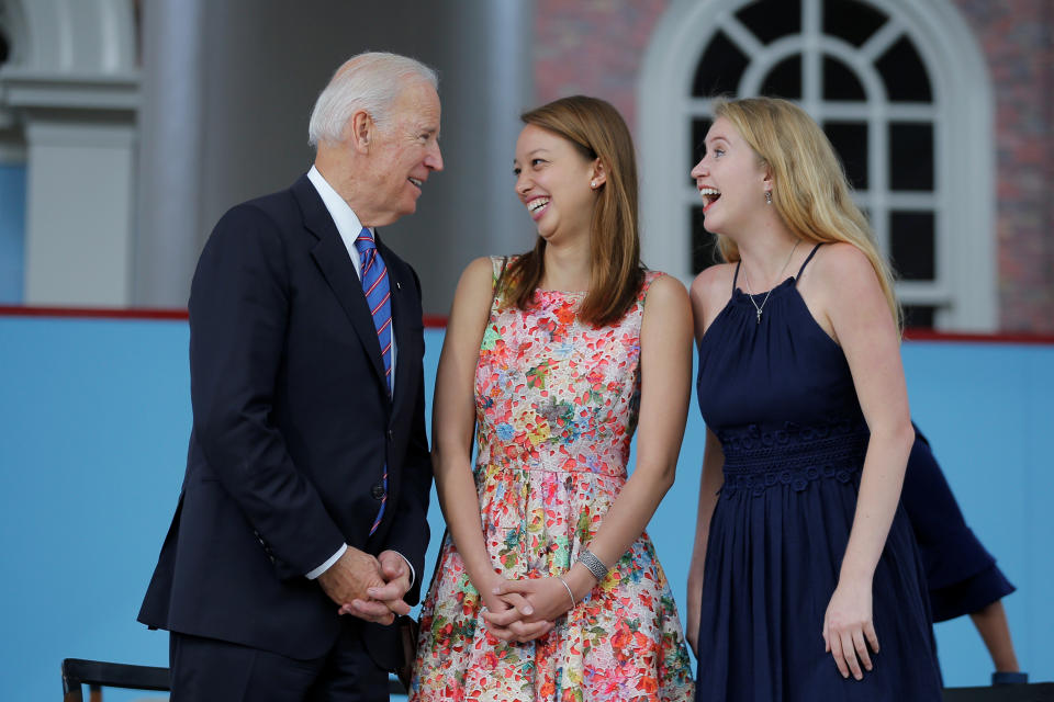 Former U.S. Vice President Joe Biden talks to graduating students Katherine Wu (C) and Victoria Jones (R) during Class Day Exercises at Harvard University in Cambridge, Massachusetts, U.S., May 24, 2017, ahead of the University's 366th Commencement Exercises.  REUTERS/Brian Snyder