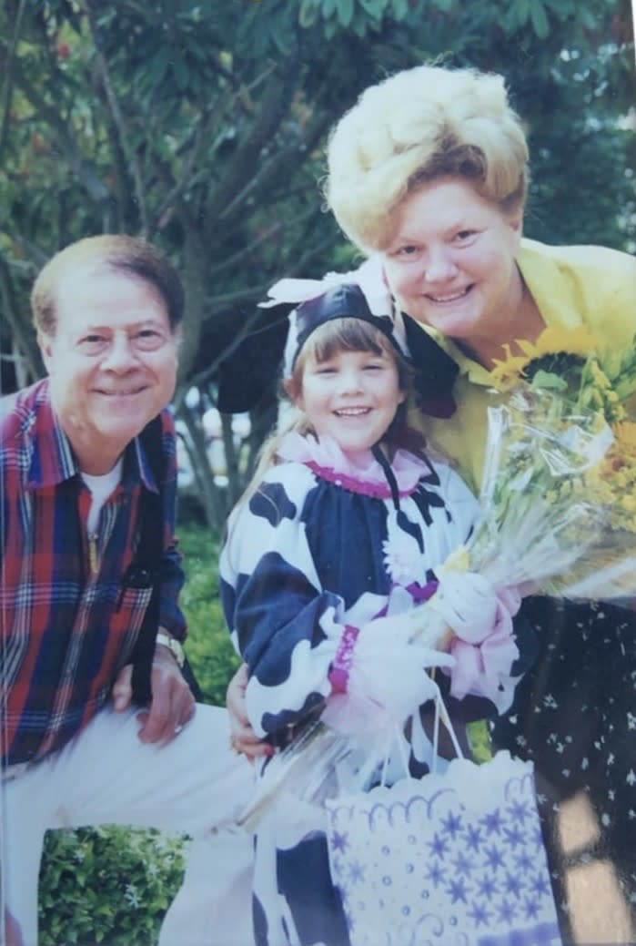 Schoellkopf, in a cow costume, poses with her grandparents at a ballet recital