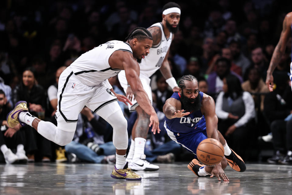 NEW YORK, NEW YORK - NOVEMBER 08: James Harden #1 of the Los Angeles Clippers and Dennis Smith Jr. #4 of the Brooklyn Nets dive for a loose ball during the fourth quarter of the game at Barclays Center on November 08, 2023 in the Brooklyn borough of New York City. NOTE TO USER: User expressly acknowledges and agrees that, by downloading and or using this photograph, User is consenting to the terms and conditions of the Getty Images License Agreement. (Photo by Dustin Satloff/Getty Images)