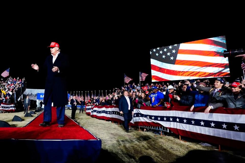 Donald Trump at a rally at night.