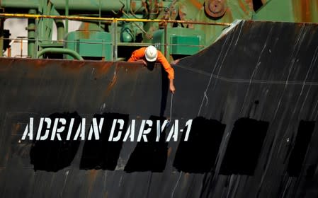 A crew member takes pictures with a mobile phone on Iranian oil tanker Adrian Darya 1, previously named Grace 1, as it sits anchored after the Supreme Court of the British territory lifted its detention order, in the Strait of Gibraltar