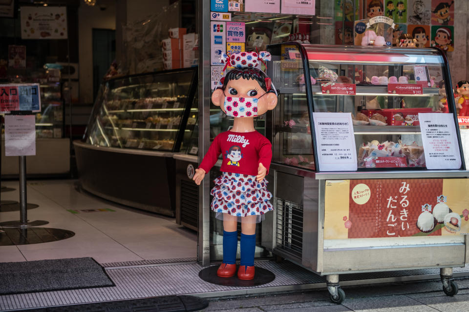 TOKYO, JAPAN - APRIL 28: An advertising doll wears a face mask as it is displayed in a shopfront in Ginza shopping district during a nationwide a state of emergency in which many shops, restaurants, cafes and businesses have closed, on April 28, 2020 in Tokyo, Japan. Japan has begun to see a slow down in Covid-19 coronavirus infections after several weeks under a state of emergency intended, amongst other things, to reduce person-to-person contact. The country has so far recorded 13,614 infections, 385 deaths and 1,899 recoveries from the virus. (Photo by Carl Court/Getty Images)