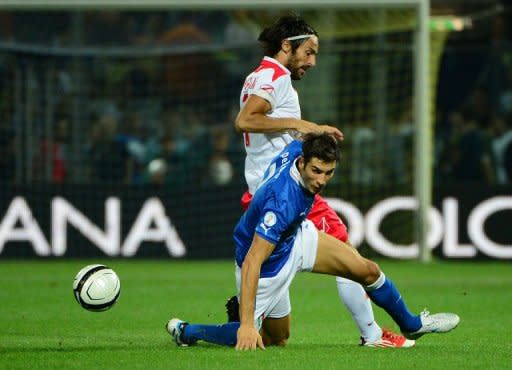 Italy's Federico Peluso (L) fights for the ball with Malta's Daniel Bogdanovic during their FIFA World Cup 2014 qualifying football match in Modena. Italy won 2-0