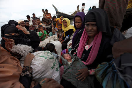 Newly arrived Rohingya refugees board a boat as they transfer to a camp in Cox's Bazar, Bangladesh, October 2, 2017. REUTERS/Cathal McNaughton