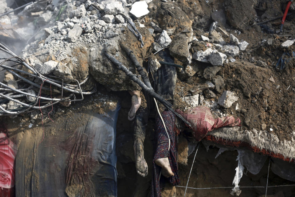 FILE - Bodies of dead Palestinians are seen under the rubble of a destroyed house after Israeli airstrikes on Gaza City, Oct. 24, 2023. News organizations are constantly weighing their job to convey reality against the concern that violent images are too traumatizing for consumers to see. (AP Photo/Abed Khaled, File)