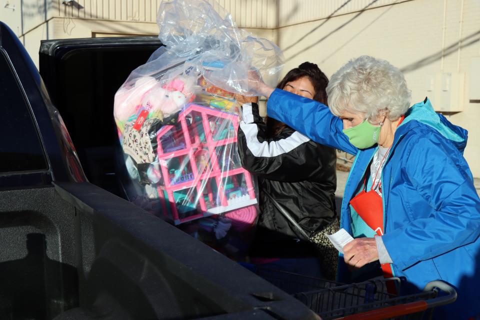 Ann Moss helps load gifts during the 2020 Salvation Army Angel Tree Distribution at Sunset Center.