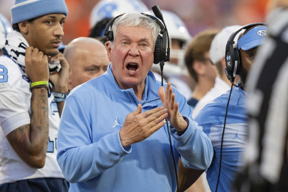 North Carolina head coach Mack Brown calls a timeout during the first half of an NCAA college football game against Clemson, Saturday, Nov. 18, 2023, in Clemson, S.C. (AP Photo/Jacob Kupferman)