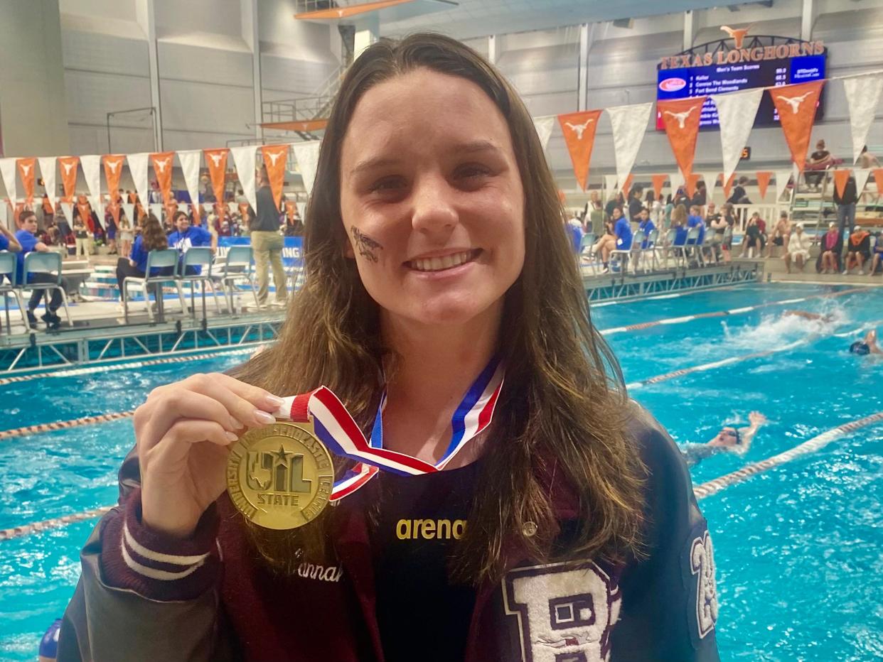 Round Rock swimmer Hannah O'Leary poses with the gold medal that she won at this past weekend's UIL state swimming and diving championships at the Jamail Texas Swimming Center. She's headed to Texas A&M this fall, where she'll continue her swimming career.