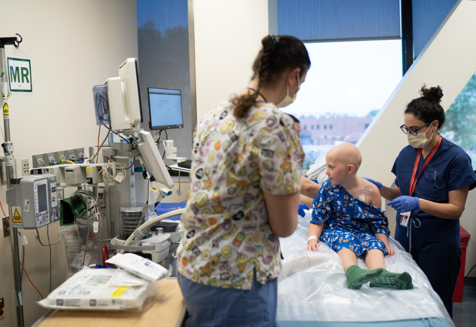 Callie Weatherford looks at medical equipment just before she is anesthetized for an innovative type of ultrasound treatment for her brain tumor at Children's National Hospital in Washington, D.C., on July 13. (Washington Post photo by Minh Connors)