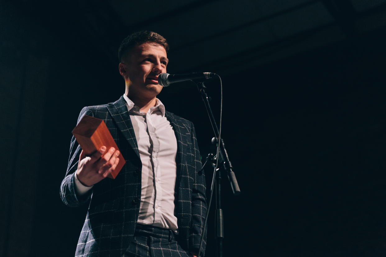 Stewart Morgan was diagnosed with testicular cancer four days after his 21st birthday. He is pictured receiving the 'Know Thy Nuts' award at the 2019 Movember ceremony. (Supplied: Movember)