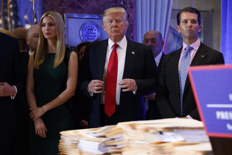 President-elect Donald Trump, accompanied by family members, waits to be introduced during a news conference in the lobby of Trump Tower in New York, Wednesday, Jan. 11, 2017. (AP Photo/Evan Vucci)