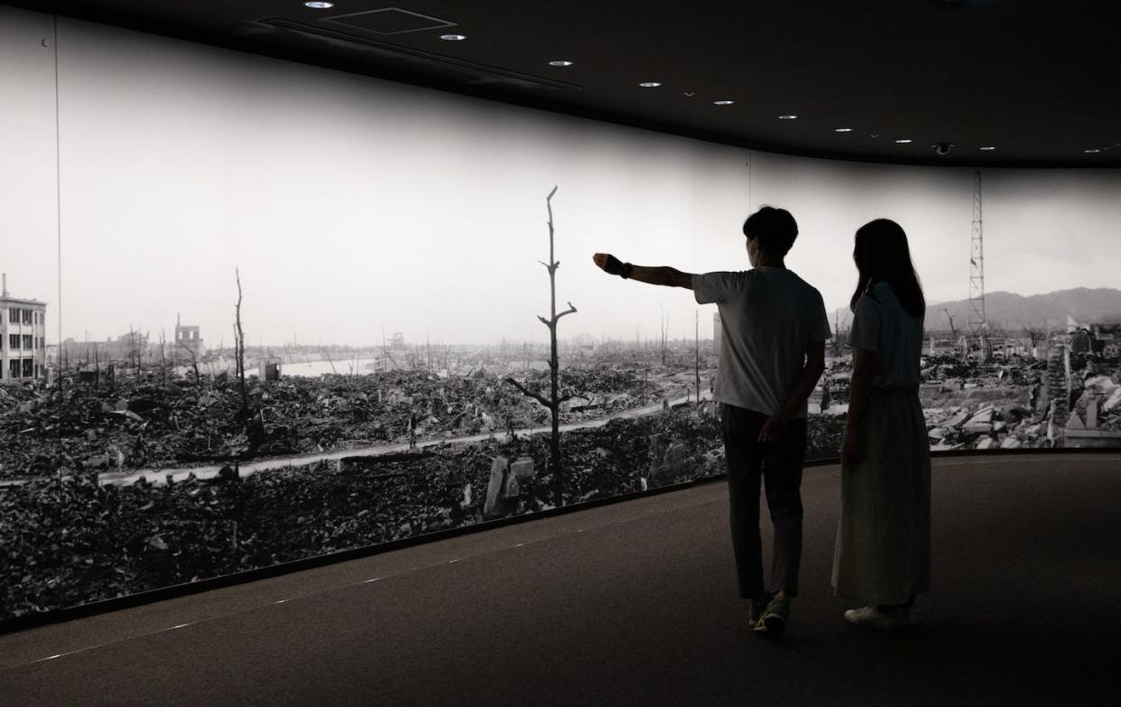 Visitors to the Hiroshima Peace Memorial Museum in Hiroshima view a large-scale panoramic photograph of the destruction following the 1945 bombing. <a href="https://www.gettyimages.com/detail/news-photo/visitors-to-hiroshima-peace-memorial-museum-view-a-large-news-photo/1227916055?adppopup=true" rel="nofollow noopener" target="_blank" data-ylk="slk:Carl Court/Getty Images;elm:context_link;itc:0;sec:content-canvas" class="link ">Carl Court/Getty Images </a>