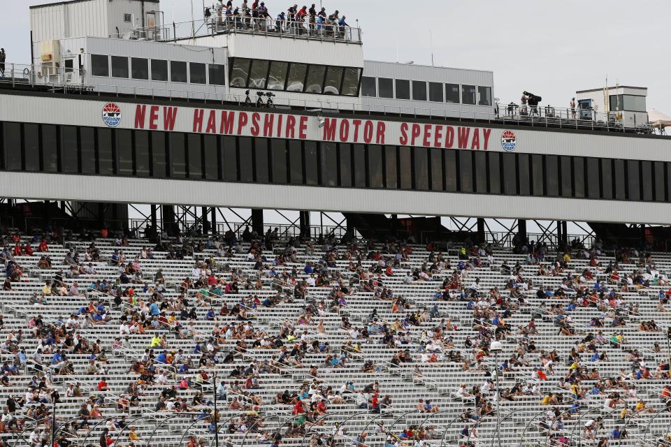 Fans sit socially distanced, due to the coronavirus pandemic, in the grandstand during a NASCAR Cup Series auto race, Sunday, Aug. 2, 2020, at the New Hampshire Motor Speedway in Loudon, N.H. (AP Photo/Charles Krupa)