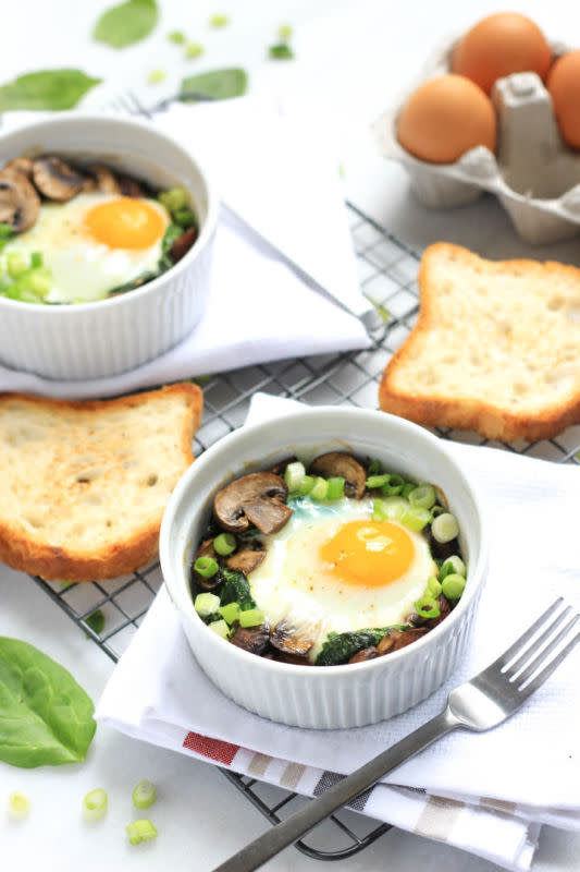 <p>Warm, baked eggs with wilted spinach and sautéed mushrooms, sprinkled with chopped spring onions. The perfect way to start any day.</p><p><a href="http://dishbydish.net/2015/10/01/baked-eggs-with-spinach-and-mushrooms/" rel="nofollow noopener" target="_blank" data-ylk="slk:Get the recipe here!;elm:context_link;itc:0;sec:content-canvas" class="link "><em><strong>Get the recipe here!</strong></em></a></p>