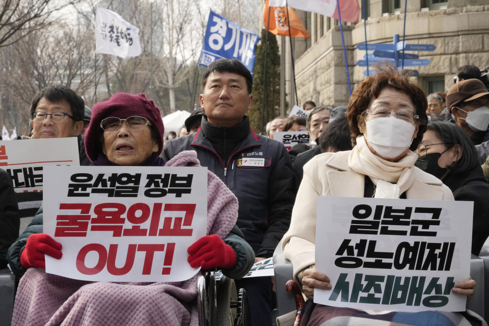 Former South Korean comfort woman Lee Yong-soo, right, and Yang Geum-deok, a South Korean victim of Japan's wartime forced labor, attend a rally against the South Korean government's move to improve relations with Japan in Seoul, South Korea, Wednesday, March 1, 2023. South Korea's president on Wednesday called Japan "a partner that shares the same universal values" and renewed hopes to repair ties frayed over Japan's colonial rule of the Korean Peninsula. The banners read "South Korean President Yoon Suk Yeol's humiliation diplomacy, left, and Japanese apology and compensation." (AP Photo/Ahn Young-joon)