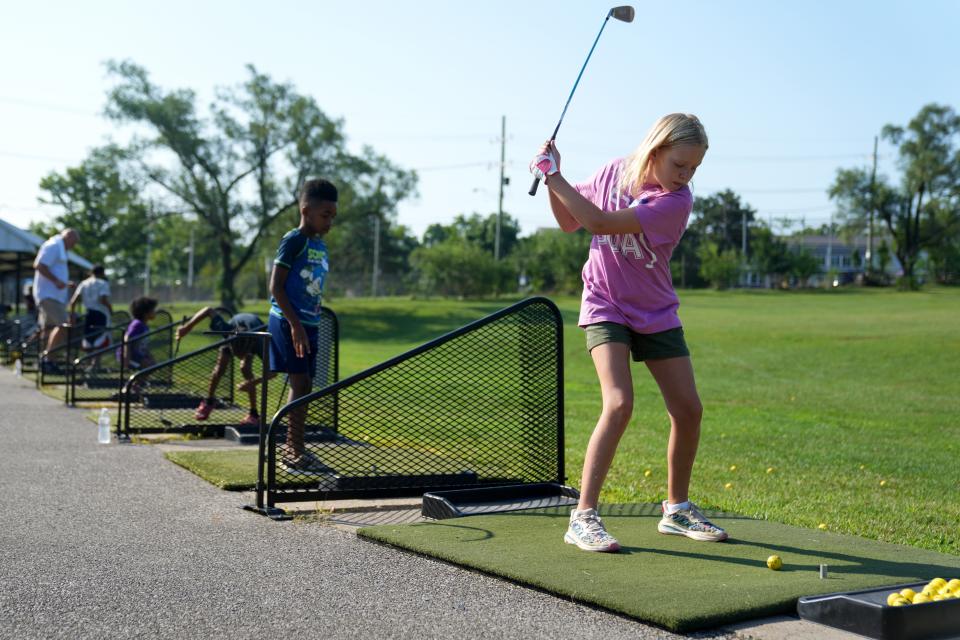 Jane Logan, 11, of Clifton, takes a swing during a July junior golf clinic hosted by Reaching Out For Kids, Inc. at Avon Fields in Avondale.