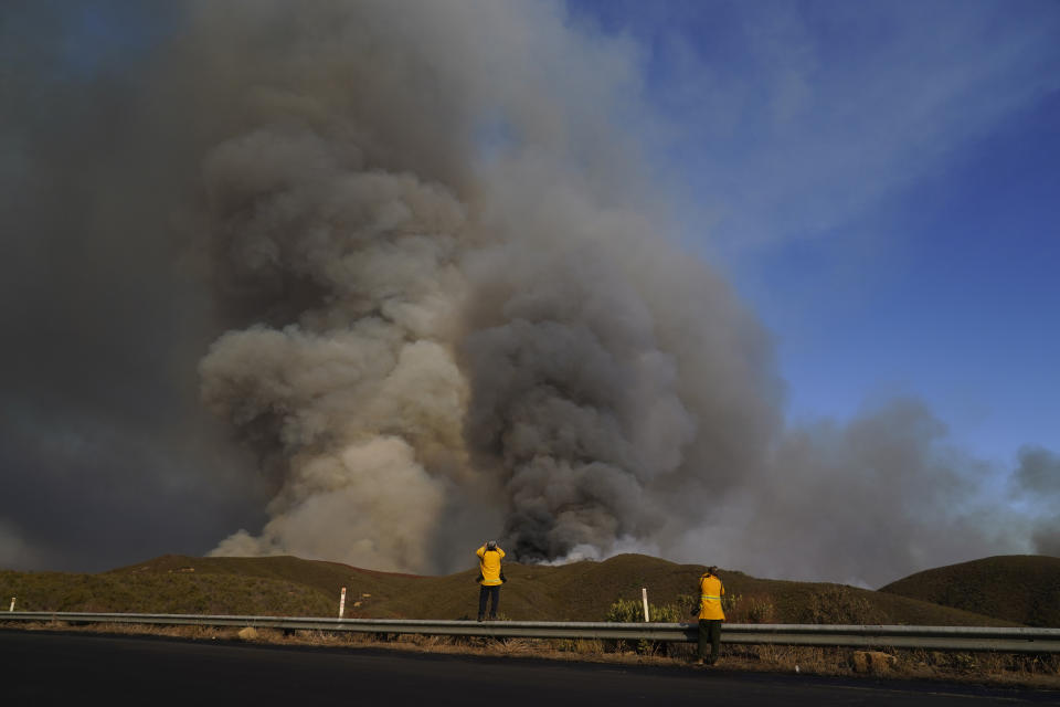 Members of the news media photograph the Route Fire Wednesday, Aug. 31, 2022, in Castaic, Calif. (AP Photo/Marcio Jose Sanchez)
