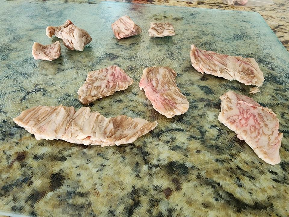 squashed pieces of wagyu steak on a kitchen counter