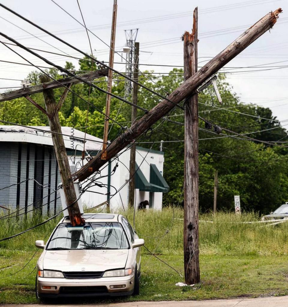 A broken utility pole rests on the top of a vehicle outside of McClure’s Auto Service on North Chester Street in Gastonia , N.C., on Thursday, May 9, 2024. Severe storms tore through the area yesterday causing property damage and power outages. Melissa Melvin-Rodriguez/mrodriguez@charlotteobserver.com