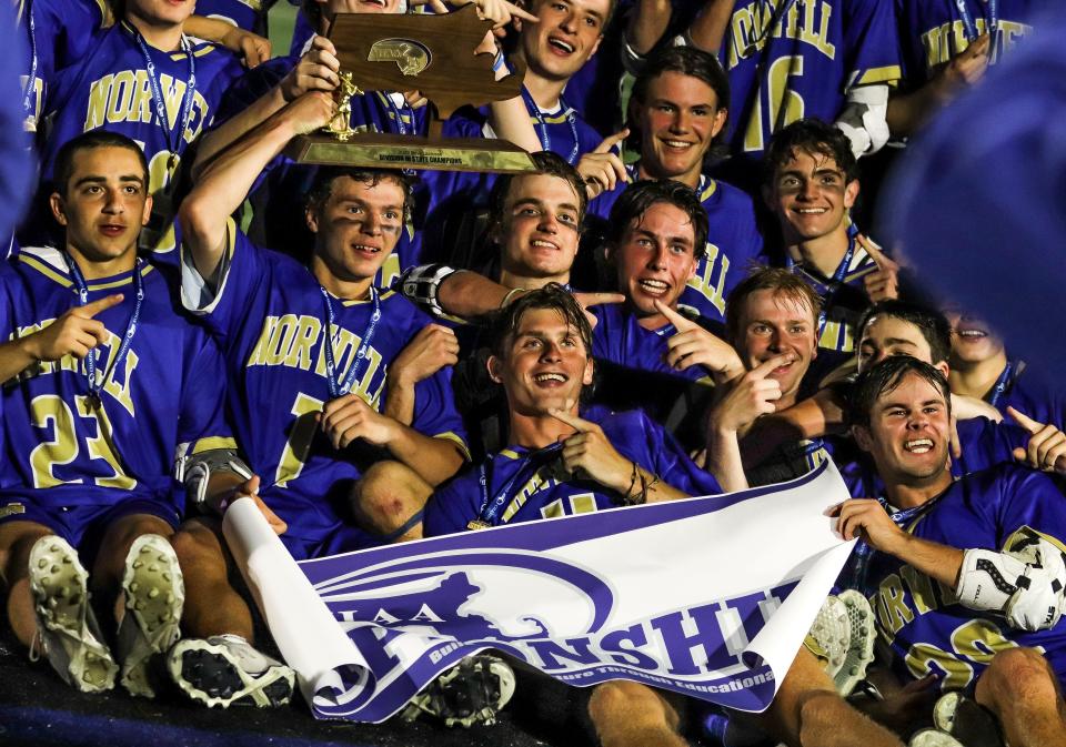 The Norwell High boys lacrosse team celebrates winning the Division 3 state title game over Medfield on the campus of Worcester State University on Wednesday, June 22, 2022.