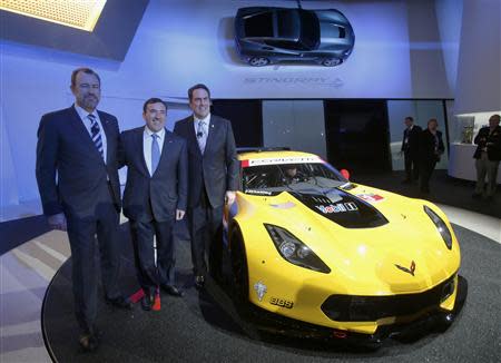 Daniel Ammann, President of GM; Alan Beaty, Vice President of Global Chevrolet; and Mark Reuss, President for GM North America (L to R), pose with the Chevrolet Corvette Stingray racing version during the press preview day of the North American International Auto Show in Detroit, Michigan January 13, 2014. REUTERS/Rebecca Cook