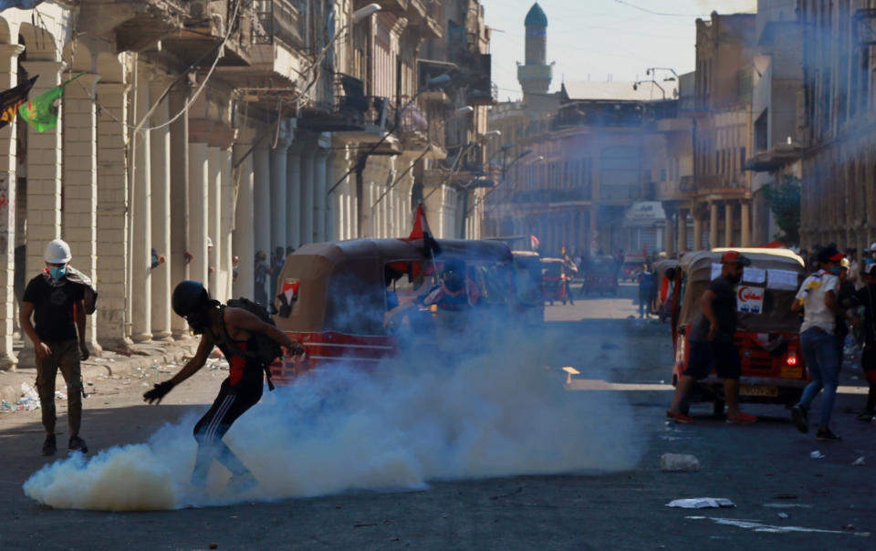 Iraqi riot police fire tear gas to disperse anti-government protesters during clashes in the al-Rasheed street in Baghdad, Iraq, Friday, Nov. 8, 2019. The demonstrators complain of widespread corruption, lack of job opportunities and poor basic services, including regular power cuts despite Iraq's vast oil reserves. They have snubbed limited economic reforms proposed by the government, calling for it to resign. (AP Photo/Khalid Mohammed)