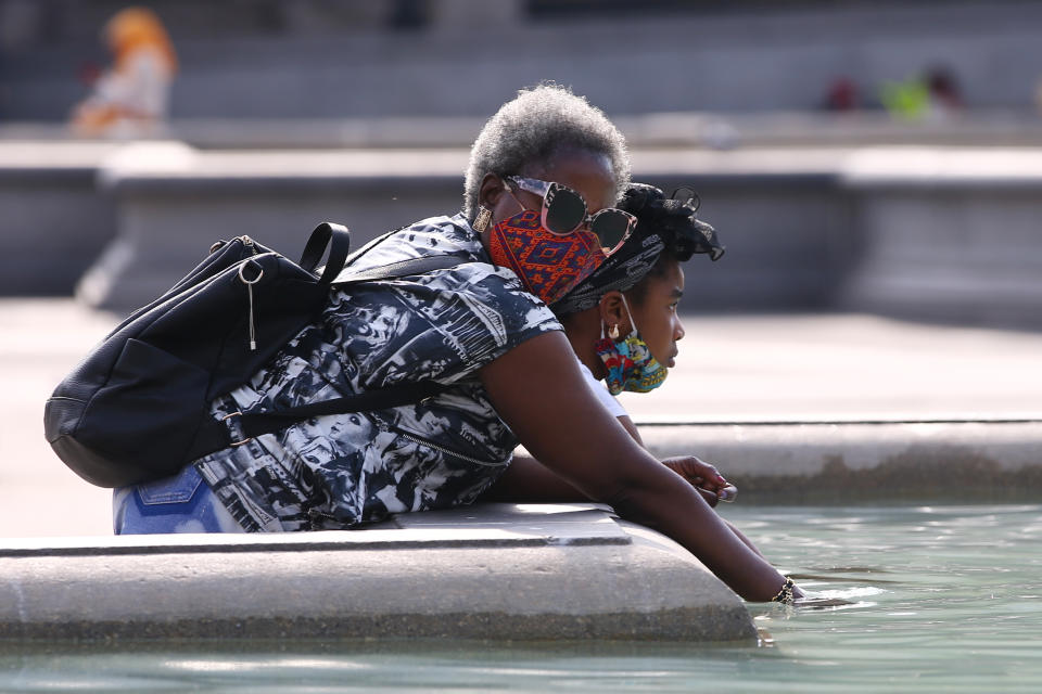 People cool off in the fountain at Trafalgar Square.