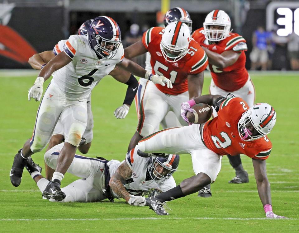 Miami running back Donald Chaney, Jr. (2) runs the ball in the second quarter of an NCAA college football game against Virginia in Miami Gardens, Fla., Saturday, Oct. 24, 2020. (Al Diaz/Miami Herald via AP)