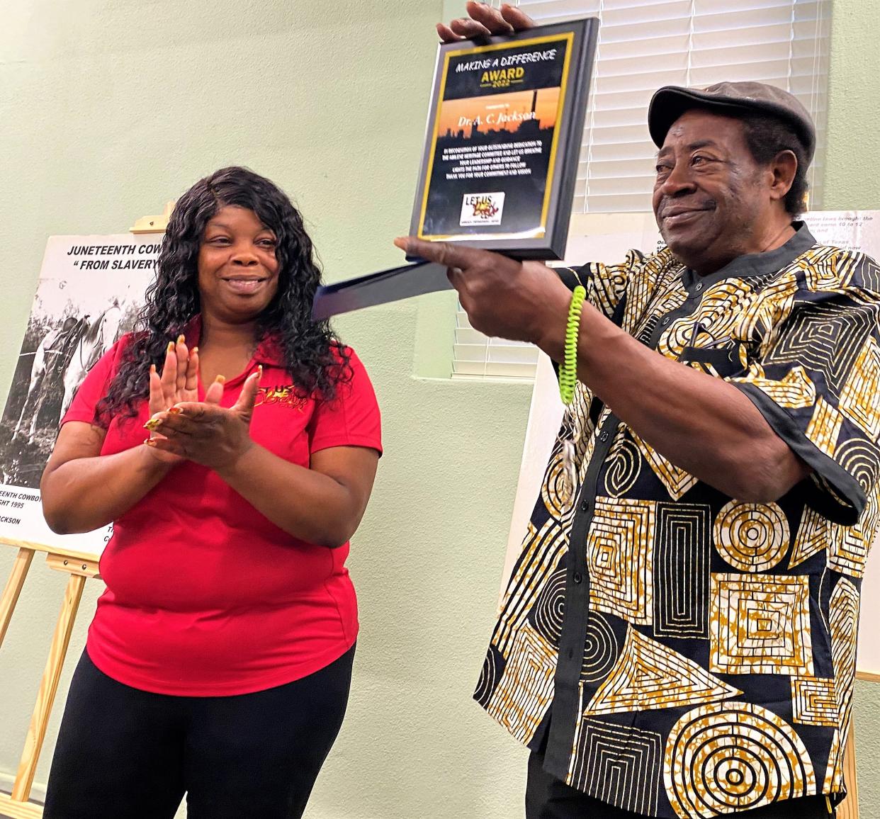 A.C. Jackson holds the Making a Difference Award from the nonprofit group Let Us Breathe, presented by found Shawnte Fleming, left, on Tuesday at the Taylor County Historical Commission Archive Building on Pecan Street.