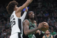 San Antonio Spurs forward Dominick Barlow (26) defends as Boston Celtics center Robert Williams drives toward the basket in the first half of an NBA basketball game, Sunday, March 26, 2023, in Boston. (AP Photo/Steven Senne)