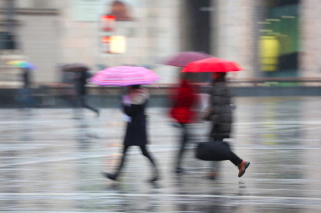 People with umbrellas during a rainy day