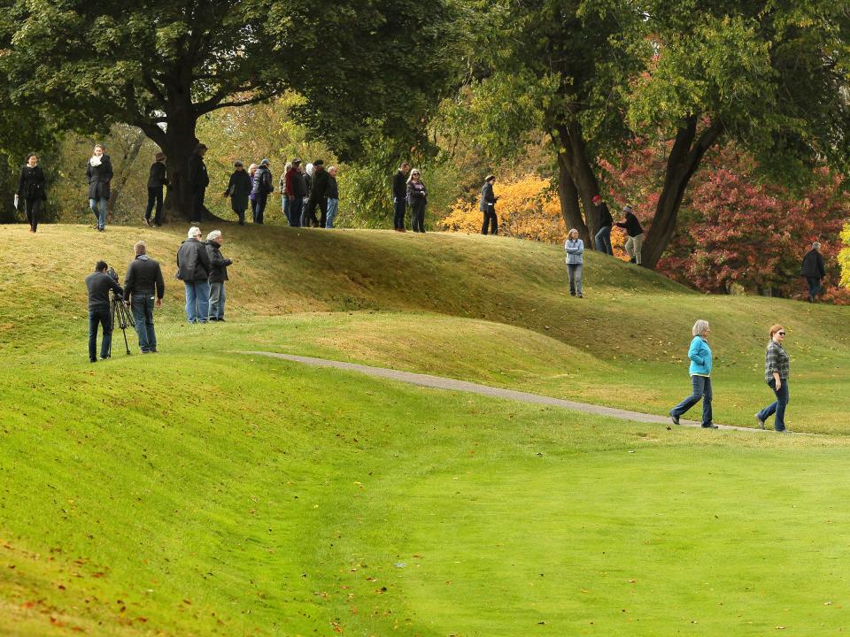 Visitors climb Observatory Mound at the Octagon Earthworks after a tour on Sunday, October 15, 2023. The Ohio History Connection held events at the Great Circle and Octagon Earthworks to celebrate their designation as UNESCO World Heritage Sites.