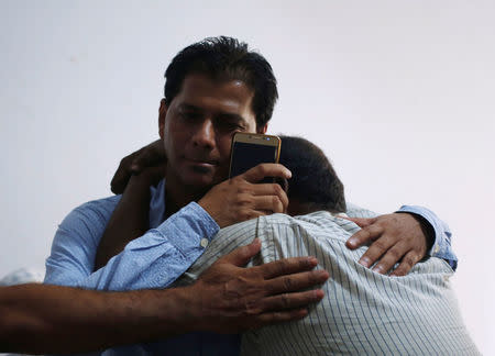 Aziz Shaikh (L), father of Sabika Aziz Sheikh, a Pakistani exchange student who was killed, is comforted by a relative at his residence in Karachi, Pakistan May 19, 2018. REUTERS/Akhtar Soomro