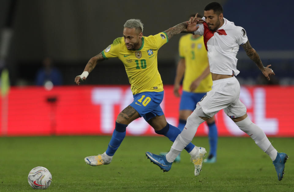 Brazil's Neymar, left, escapes with the ball from Peru's Sergio Pena during a Copa America semifinal soccer match at Nilton Santos stadium in Rio de Janeiro, Brazil, Monday, July 5, 2021. (AP Photo/Silvia Izquierdo)