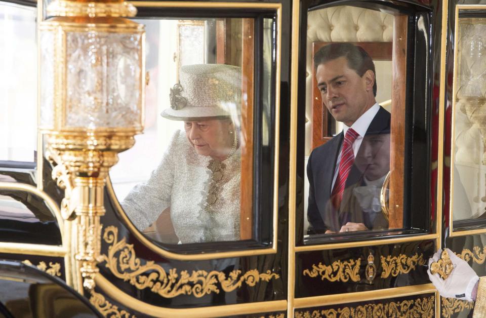 Britain's Queen Elizabeth and Mexico's President Enrique Pena Nieto ride a carriage as they leave Horse Guards Parade in London