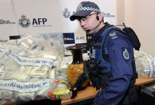 Australian Federal Police guard US$525 million worth of crystal methamphetamine ('ice') and heroin after smashing a Hong Kong-based international drugs syndicate in Sydney on July 31, 2012