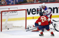 New York Rangers left wing Alexis Lafreniere (13) scores against Florida Panthers goaltender Sergei Bobrovsky (obscured) during the second period of an NHL hockey game Saturday, March 25, 2023, in Sunrise, Fla. (AP Photo/Rhona Wise)