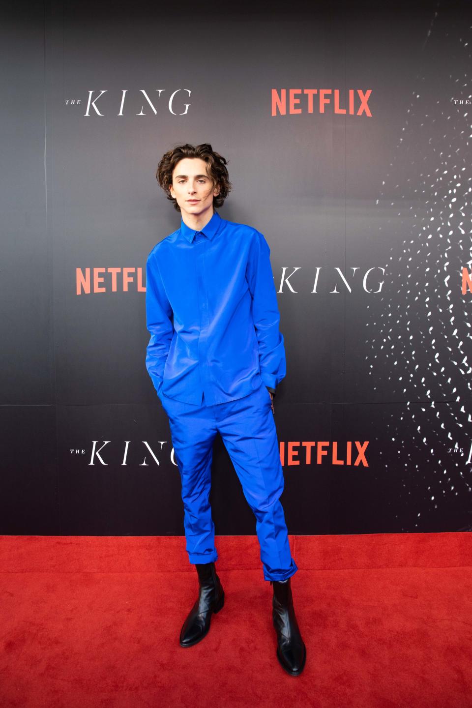 A photo of Timotheé Chalamet wearing a blue shirt and pants at The King Sydney premiere.