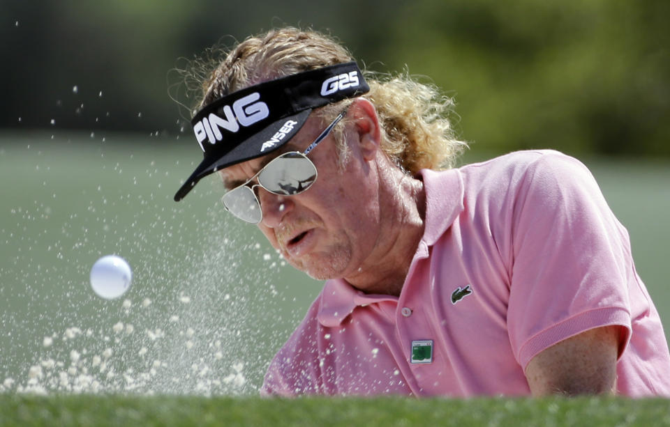 Miguel Angel Jimenez, of Spain, hits out of a bunker on the 18th hole during the first round of the Masters golf tournament Thursday, April 10, 2014, in Augusta, Ga. (AP Photo/David J. Phillip)