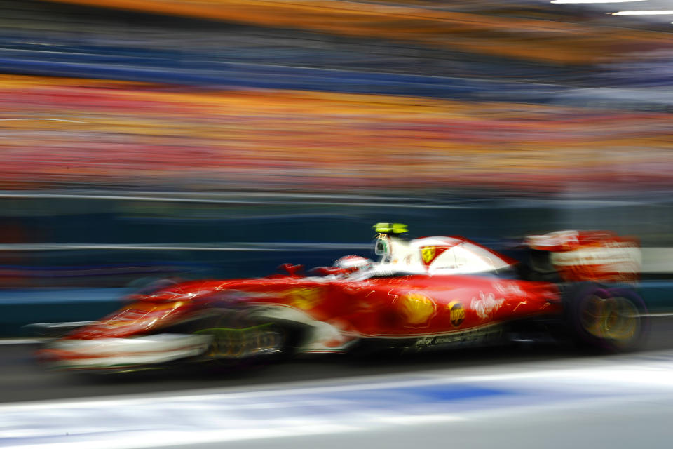 A blur of speed: Kimi Raikkonen gives it the beans during the 2016 Singapore Grand Prix