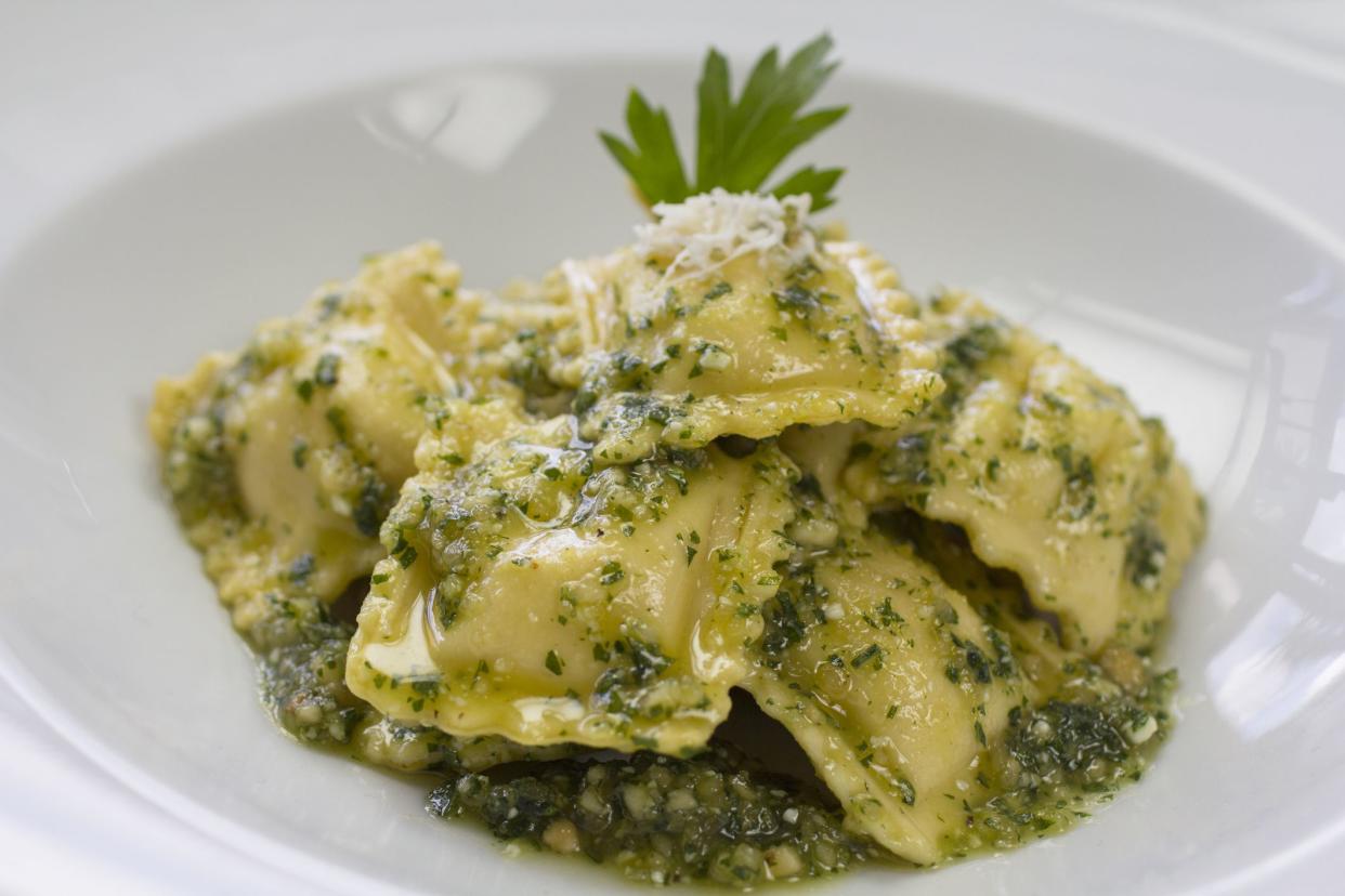 Italian raviolis stuffed with ricotta cheese, spinach and served with pesto sauce and grated parmesan cheese.